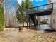 A concrete patio and fire pit are beneath a dark wood elevated deck in this backyard space at 2536 Kachina Trl, Dacula, GA 30019
