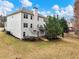 Spacious backyard and exterior view of house with trees, manicured lawn, and upper level deck at 2536 Kachina Trl, Dacula, GA 30019