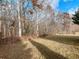 An expansive backyard with mature trees provides shade and privacy at 2536 Kachina Trl, Dacula, GA 30019