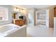 Bathroom featuring a soaking tub, and vanity with countertop space. Bedroom in the background at 2536 Kachina Trl, Dacula, GA 30019