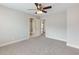 Spacious carpeted bedroom features a modern ceiling fan and view of the attached bathroom at 2536 Kachina Trl, Dacula, GA 30019
