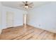 Open bedroom with hardwood floors, white walls, and doors offering a blank slate for decor at 2536 Kachina Trl, Dacula, GA 30019