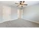 Comfortable bedroom with a ceiling fan, neutral paint, and soft carpeting at 2536 Kachina Trl, Dacula, GA 30019
