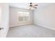 Comfortable bedroom with a ceiling fan, a large window, neutral paint, and soft carpeting at 2536 Kachina Trl, Dacula, GA 30019