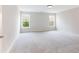 Spacious carpeted bedroom features two large windows providing ample natural light and backyard views at 2536 Kachina Trl, Dacula, GA 30019
