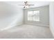 Bright bedroom featuring neutral carpet, ceiling fan, and a window offering lots of natural light at 2536 Kachina Trl, Dacula, GA 30019