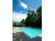 Inviting community pool with crystal-clear water, surrounded by lush greenery and ample seating at 2536 Kachina Trl, Dacula, GA 30019