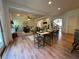 Open-concept dining room and living room area features a ceiling fan and light wood floors at 2536 Kachina Trl, Dacula, GA 30019