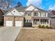 Beautiful two-story brick home with a two-car garage and a covered front porch at 2536 Kachina Trl, Dacula, GA 30019