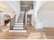 Bright foyer with hardwood floors and an open staircase with decorative iron railing at 2536 Kachina Trl, Dacula, GA 30019