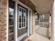 Close-up of front entry with sidelights and covered porch with columns at 2536 Kachina Trl, Dacula, GA 30019