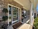 Charming brick home featuring a welcoming front porch with brick pillars and manicured shrubbery at 2536 Kachina Trl, Dacula, GA 30019