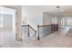 Upstairs hallway with carpet and wood railing offering access to multiple rooms at 2536 Kachina Trl, Dacula, GA 30019