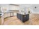 Open-concept kitchen features white cabinetry, an island, and stainless steel appliances at 2536 Kachina Trl, Dacula, GA 30019
