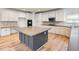 Well-lit kitchen with white cabinets, dark countertops, and a central island at 2536 Kachina Trl, Dacula, GA 30019