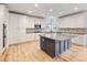 Modern kitchen boasts white cabinetry, stainless steel appliances, and a center island at 2536 Kachina Trl, Dacula, GA 30019