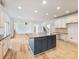 Open kitchen with white cabinets, stainless steel appliances, and center island at 2536 Kachina Trl, Dacula, GA 30019