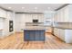 Bright kitchen with white cabinets, large dark island, and modern appliances at 2536 Kachina Trl, Dacula, GA 30019