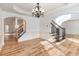 Spacious living room featuring an archway entrance, stairs, and ample natural light at 2536 Kachina Trl, Dacula, GA 30019
