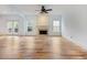 Bright living room featuring a fireplace, hardwood floors, and sliding glass door at 2536 Kachina Trl, Dacula, GA 30019