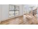 Bright open-concept living room with hardwood floors and large windows at 2536 Kachina Trl, Dacula, GA 30019
