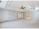 Spacious main bedroom featuring neutral carpeting and a tray ceiling at 2536 Kachina Trl, Dacula, GA 30019