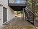 Back patio with a covered deck above and stairs leading to the backyard at 2536 Kachina Trl, Dacula, GA 30019