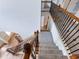 Carpeted staircase with decorative metal and wood railings, ascending to the upper level at 2536 Kachina Trl, Dacula, GA 30019