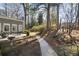 Secluded backyard featuring a patio area, a stone walkway, and mature trees at 2630 Orchard Knob Se, Atlanta, GA 30339