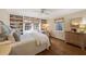 Bedroom featuring built-in bookshelves, hardwood floors, and natural light at 2630 Orchard Knob Se, Atlanta, GA 30339