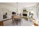 Cozy dining area with fireplace, bright windows and a round wooden table at 2630 Orchard Knob Se, Atlanta, GA 30339
