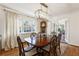 Elegant dining room featuring a large wooden table, modern lighting, and views of the backyard at 2630 Orchard Knob Se, Atlanta, GA 30339