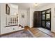 Inviting foyer with wood floors, staircase and view of the front door at 2630 Orchard Knob Se, Atlanta, GA 30339