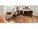 Comfortable living room with fireplace, plush seating, and large windows with shutters at 2630 Orchard Knob Se, Atlanta, GA 30339