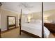Bright main bedroom with a four-poster bed, large mirror, and a glimpse into the walk-in closet at 2630 Orchard Knob Se, Atlanta, GA 30339