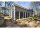 A charming screened porch nestled in a lush landscape offers an inviting space for relaxation and outdoor living at 2630 Orchard Knob Se, Atlanta, GA 30339
