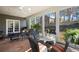 Relaxing sunroom with wicker seating and views of the wooded landscape at 2630 Orchard Knob Se, Atlanta, GA 30339