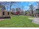 Large backyard with lush green grass and mature trees perfect for outdoor activities at 3136 Taffy Ln, Snellville, GA 30039