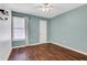 This bedroom has a ceiling fan, window with blinds and wood look floors at 3136 Taffy Ln, Snellville, GA 30039