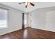Bright bedroom featuring hardwood floors, ceiling fan, and an ensuite bathroom at 3136 Taffy Ln, Snellville, GA 30039