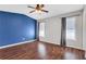 Spacious bedroom featuring hardwood floors, ceiling fan, and natural light from two large windows at 3136 Taffy Ln, Snellville, GA 30039