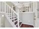 Bright entryway with hardwood floors, white railings, and stairs leading to an open living space at 3136 Taffy Ln, Snellville, GA 30039