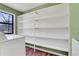 Bright laundry room featuring built in shelves and a window for natural light at 3136 Taffy Ln, Snellville, GA 30039