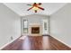 Cozy living room featuring hardwood floors, a fireplace, ample natural light, and neutral paint at 3136 Taffy Ln, Snellville, GA 30039
