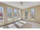 Charming sunroom featuring tile flooring, a ceiling fan, and many windows at 3136 Taffy Ln, Snellville, GA 30039