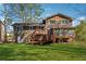 Spacious backyard showcasing home's back exterior, deck, and lush green lawn at 4453 Abingdon Dr, Stone Mountain, GA 30083