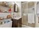 Small bathroom featuring shower, vanity, mirror, tile wall, and built-in shelving at 4453 Abingdon Dr, Stone Mountain, GA 30083