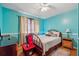 Comfortable bedroom with a bed, natural light from the window, and a bedside table with a lamp at 4453 Abingdon Dr, Stone Mountain, GA 30083