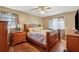 Spacious bedroom featuring a wooden bed frame, hardwood floors, and ample natural light at 4453 Abingdon Dr, Stone Mountain, GA 30083