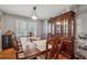 Elegant dining room with a large wooden table and a matching china cabinet at 4453 Abingdon Dr, Stone Mountain, GA 30083